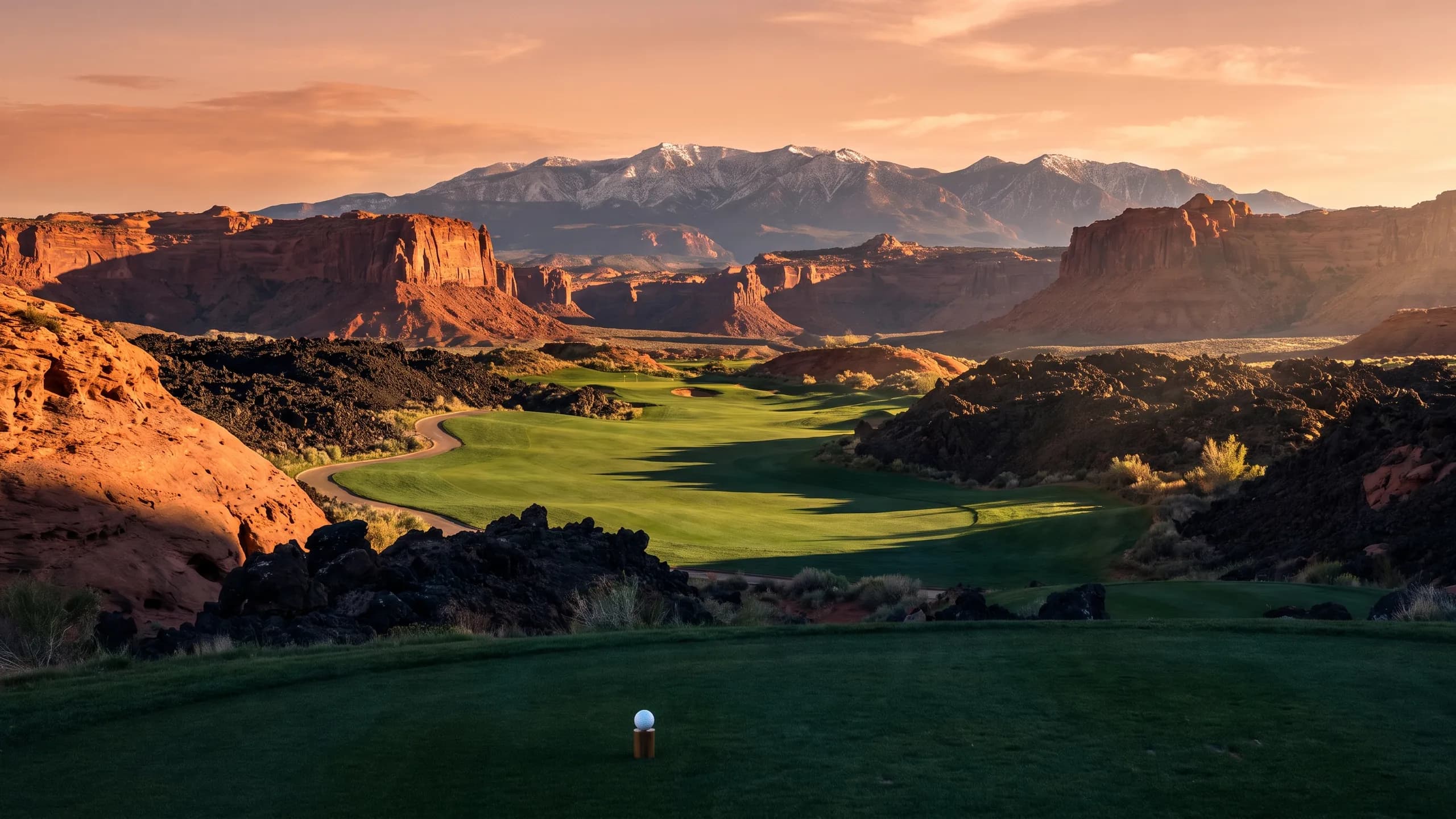 Golf fairway between red cliffs and lava rock near Hurricane, Utah at golden hour