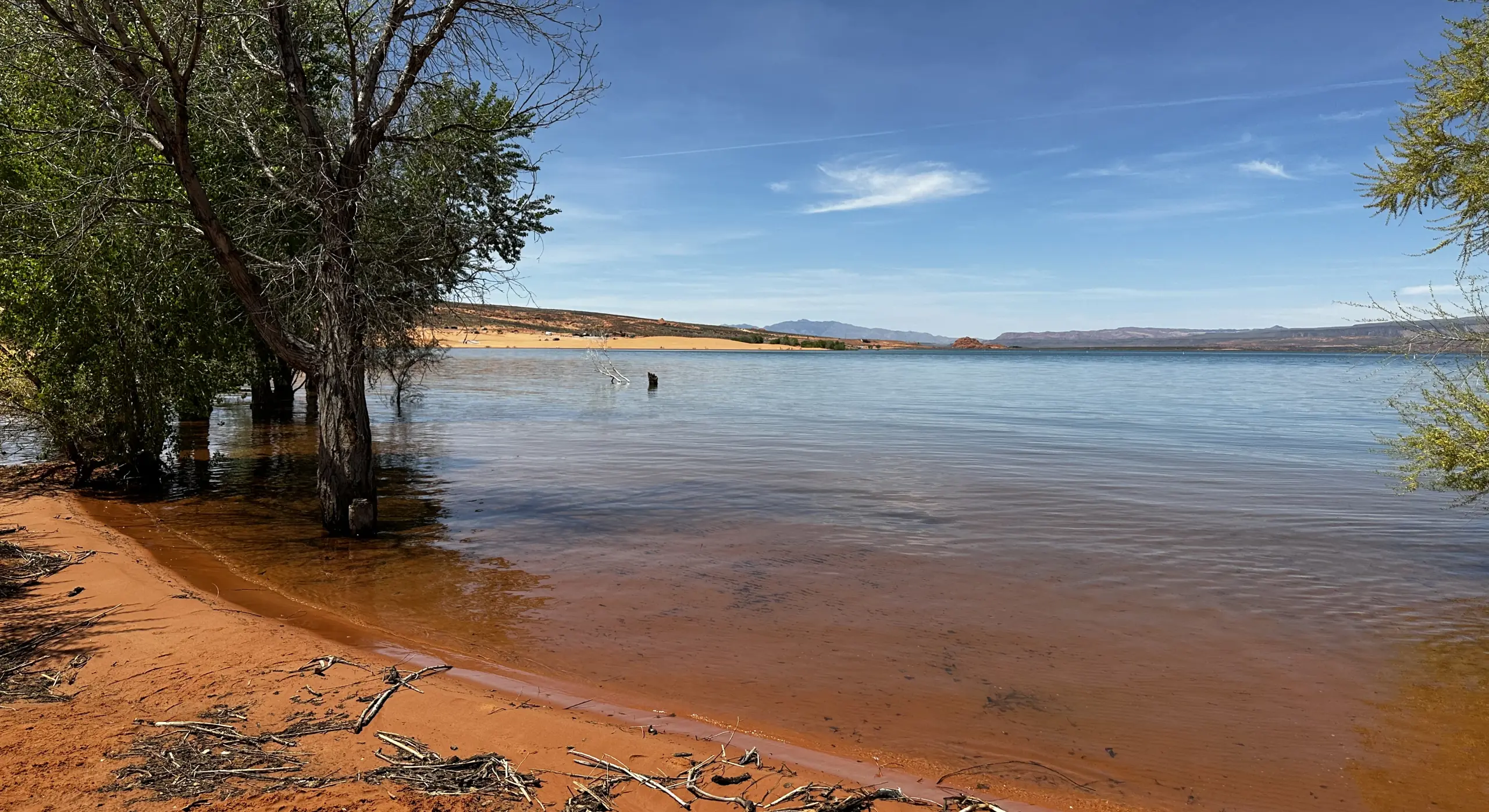 Red sand beach and blue water at a Southern Utah reservoir